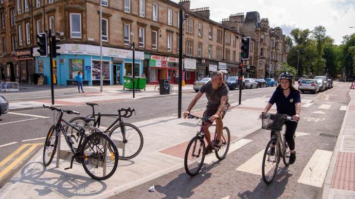 Two cyclists in a protected cycle lane