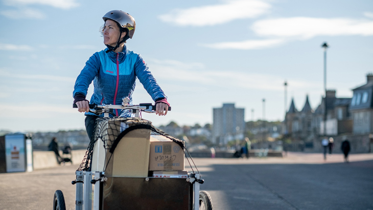 woman on a cargo bike filled with boxes