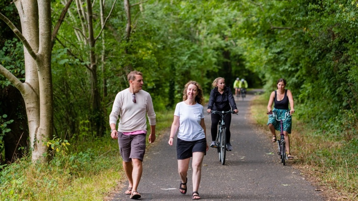 People walking and cycling along a traffic-free shared-use path