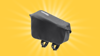 A black Ortlieb cycle frame fuel pack against a bright yellow background. It is a small pouch with clips which you can fasten on to a bicycle frame.