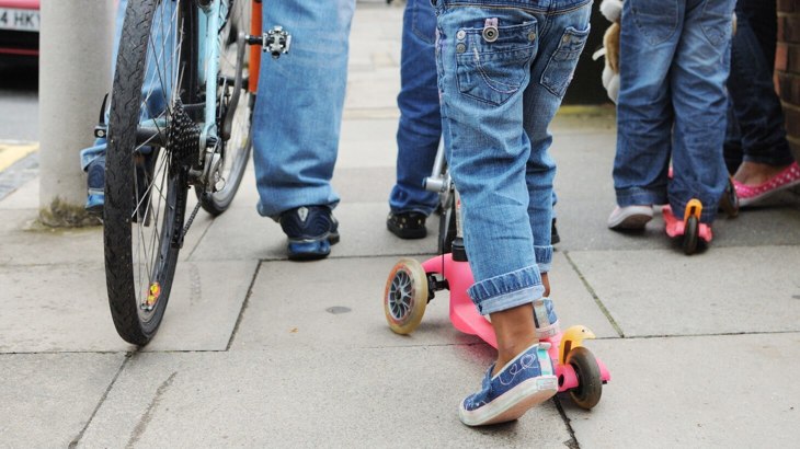 Adults and children walking and scooting 