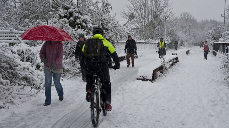 Commuters in Bristol walking and cycling in heavy snow