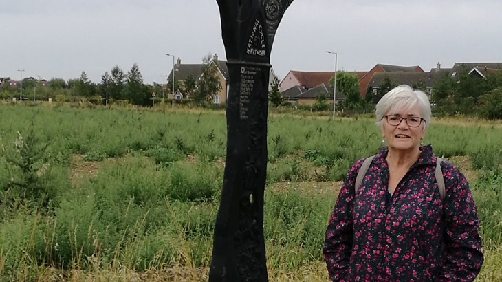 Penny stood next to a millennium milepost on the National Cycle Network