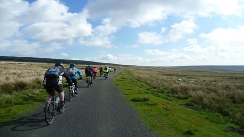 People cycling along a traffic-free National Cycle Network route in Land's End.