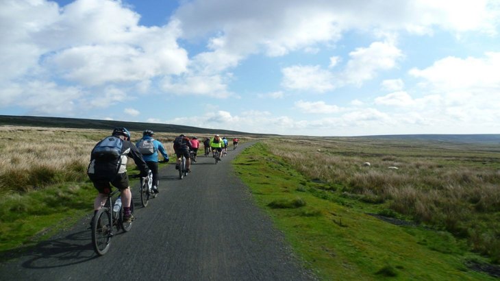 People cycling along a traffic-free National Cycle Network route in Land's End.