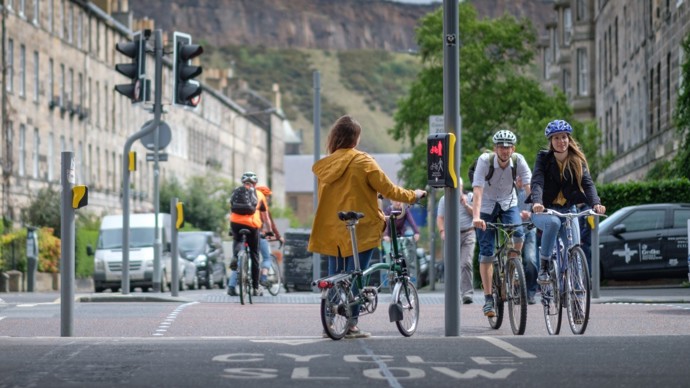 A Woman Standing At Some Traffic Lights In Edinburgh