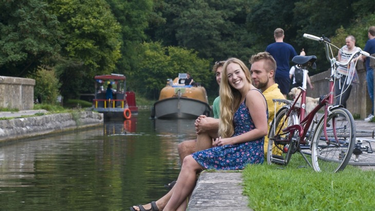 Friends Sitting By Canal