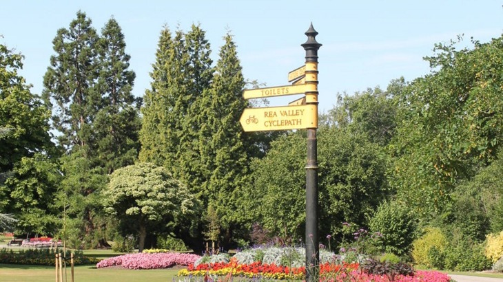 Direction signs in park for Rea Valley Cycle Path and Toilets