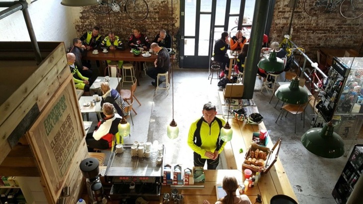 Cycle friendly cafe with man ordering a coffee at counter