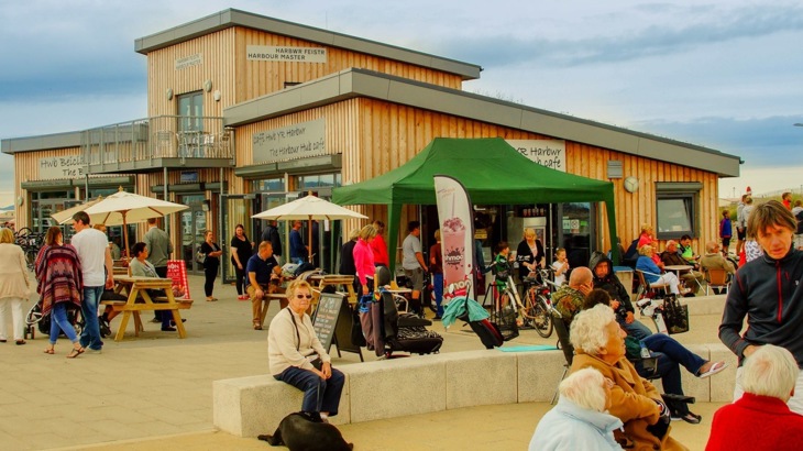 Cycle friendly cafe with man ordering a coffee at counter