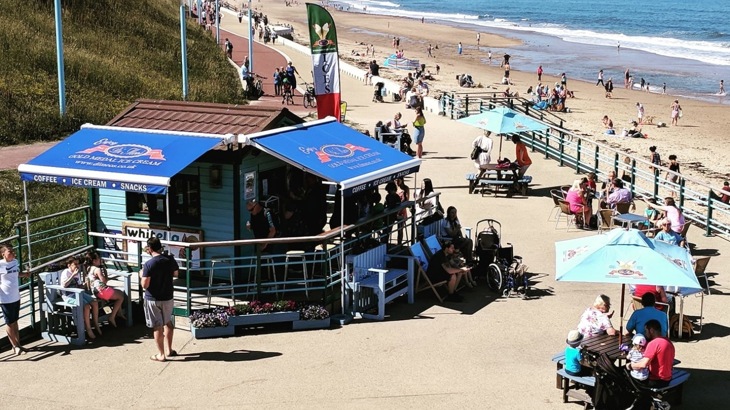 People outside seaside ice-cream shop Di Meos