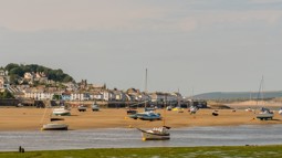 Yachts and boats in harbour of Devon town with the tide out