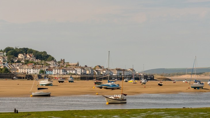 Yachts and boats in harbour of Devon town with the tide out