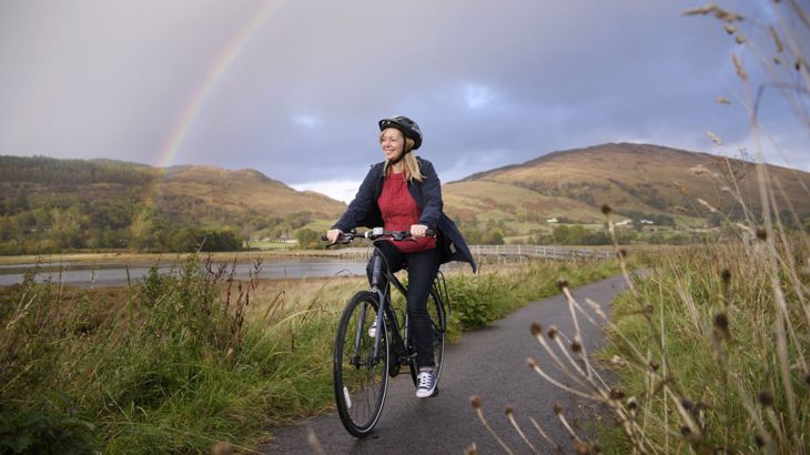 Lady cyclist with Rainbow