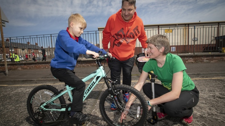 Walk Wheel Cycle Trust schools officer with dad and son on bike