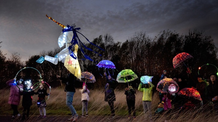 Children holding lit up umbrellas at The Circus of Light