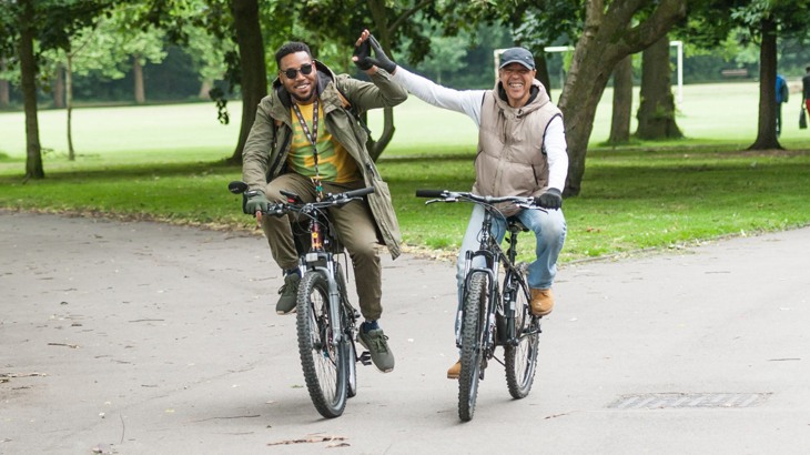 High-fiving cyclists