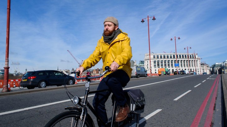 Man Cycling Over Bridge In London