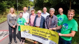 Walk Wheel Cycle Trust staff pose with local residents by the side of the Bristol and Bath Railway Path, holding a public consultation banner.