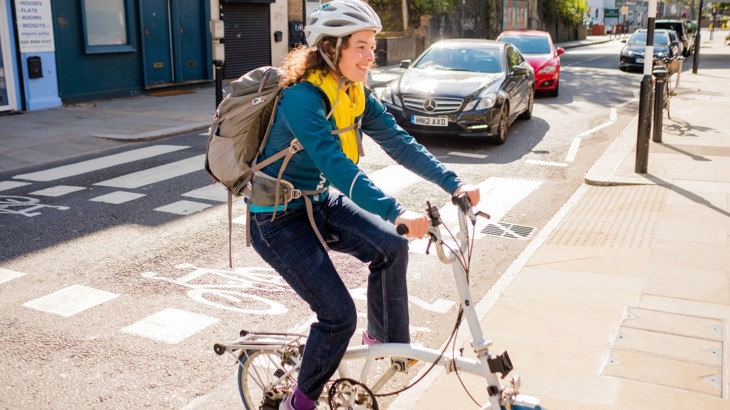 woman on folding bike zebra crossing