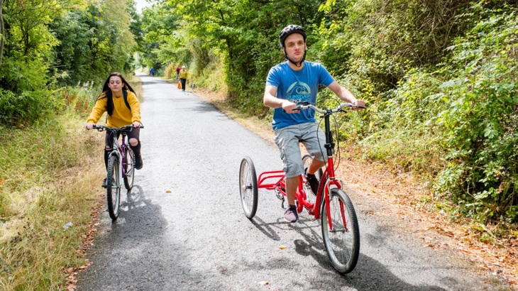An adapted bicycle and a push  bike ride along a traffic-free path