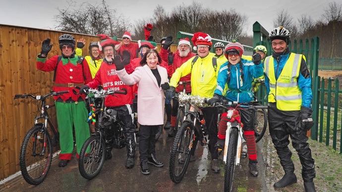 A group of people dressed as Santa and elves pose for a photo on the Castleford Greenway