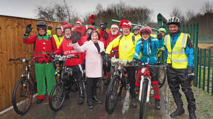 A group of people dressed as Santa and elves pose for a photo on the Castleford Greenway