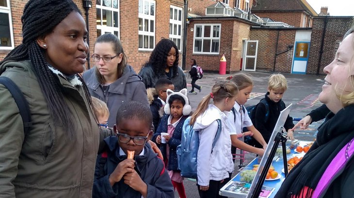 A family talking to a Walk Wheel Cycle Trust officer outside school