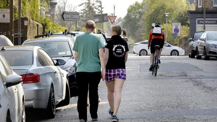 People walking and cycling on a road whilst social distancing
