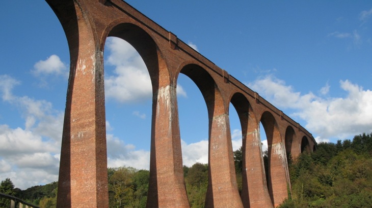 A tall red brick railway viaduct