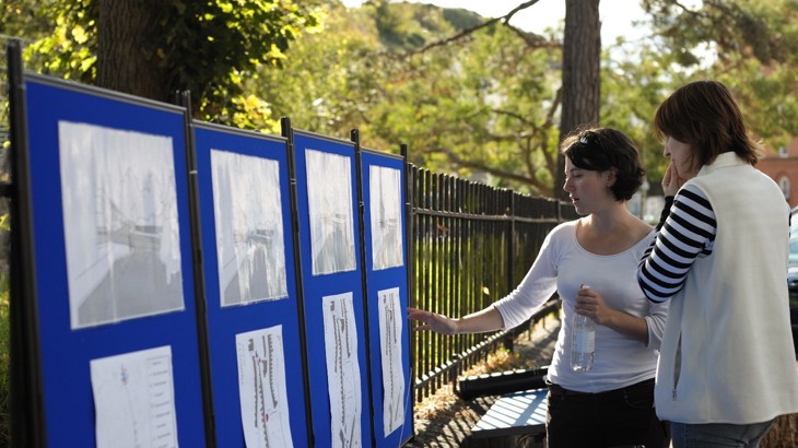 Two women look at street plans during community consultation 