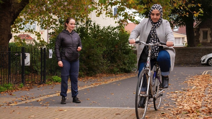 Woman learns to ride a bike