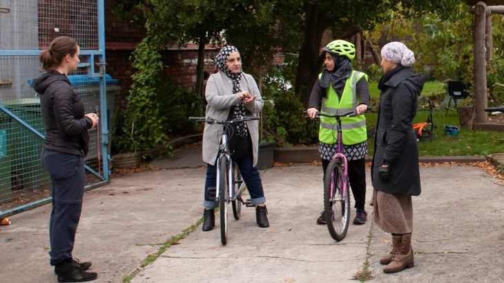 Small group of women discussing learning to cycle