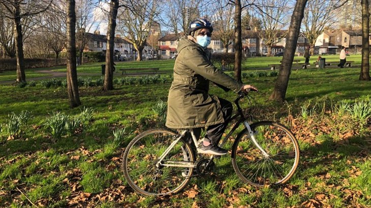 Woman getting onto a bike 