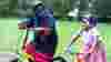 Mother and daughter cycling in Chrisp Street, Tower Hamlets
