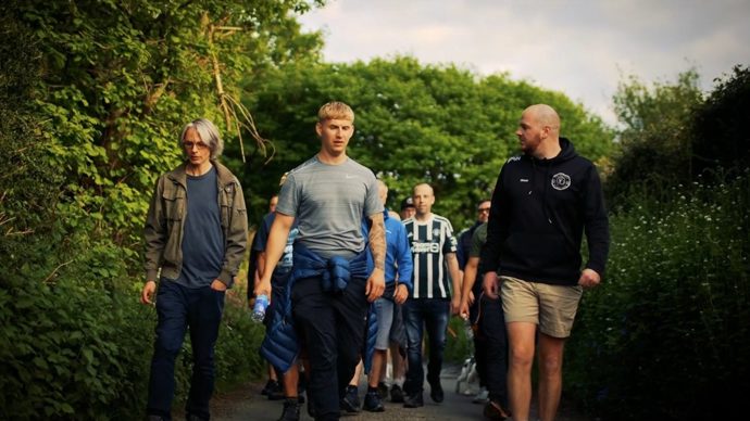 The Men.Talk.Walk men's mental health walking group on a country lane in Abertridwr, led by Shaun Cook.
