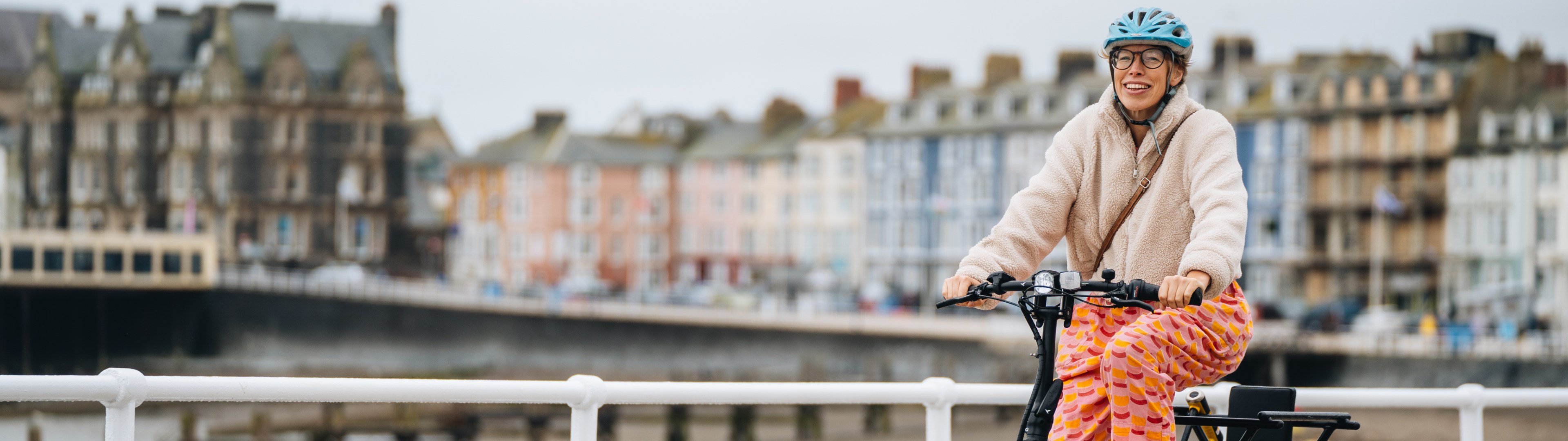 Woman On E-Bike Along Seafront
